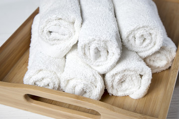 Fototapeta na wymiar the White spa towels pile in tray isolated on white background