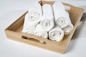 the White spa towels pile in tray isolated on white background