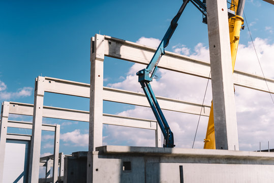 Installation of prefabricated cement pillars and beams on construction site