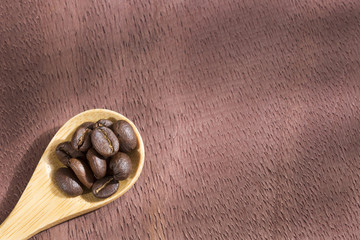 Roasted coffee on the wooden background - Coffee