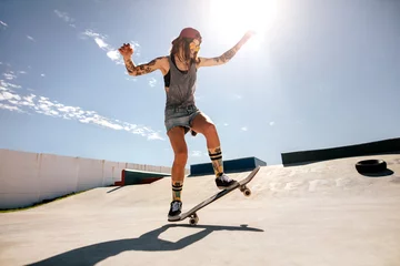 Afwasbaar fotobehang Female skater skateboarding at skate park. © Jacob Lund
