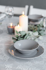 Wedding or festive table setting. Plates, wine glasses, candles and cutlery