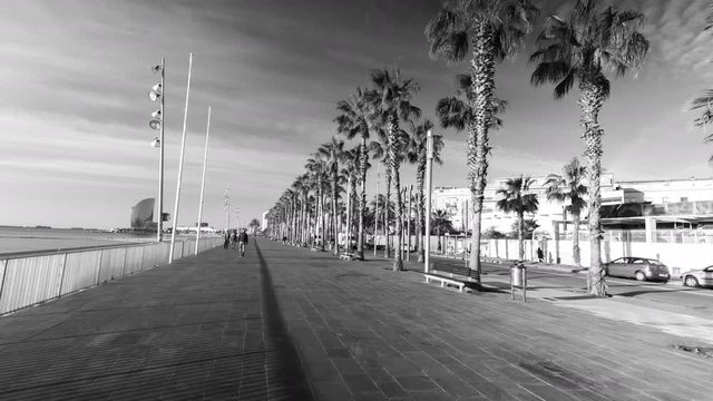 pov shot travelling around the beach  in Barcelona in the early morning on an electric skateboard