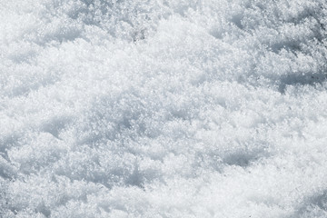 relief of white snow in the mountains in the sun textural background