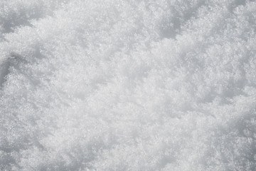 relief of white snow in the mountains in the sun textural background