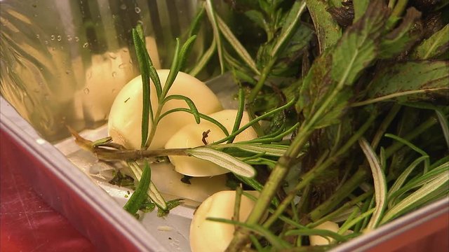 A medium shot of a person chopping garlic