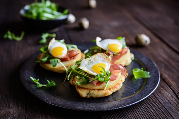 Savoury yoghurt and scallion pancakes with Black Forrest ham, smoked cheese slices, quail egg and arugula