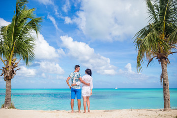 Young couple on white beach. Happy family on honeymoon vacation