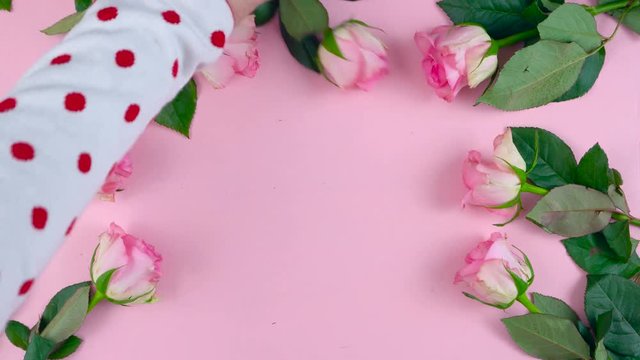 Happy Mother's Day background of pink roses and macaron cookies on pink wood table.