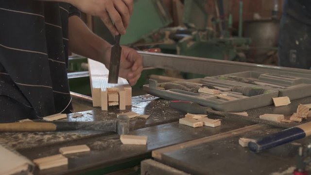 Carpenter working with hammer and chisel
