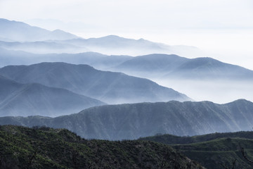 Fototapeta na wymiar Layers of misty ridges in the San Gabriel Mountains in Los Angeles County, California