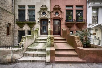 a row of colorful brownstone buildings in a historic neighborhood of Brooklyn in New York City