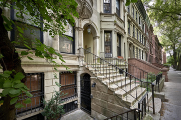 Fototapeta na wymiar a row of colorful brownstone buildings in a historic neighborhood of Brooklyn in New York City