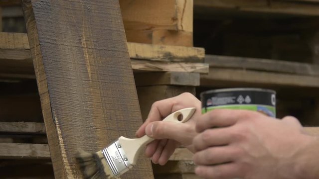 Hands staining wood