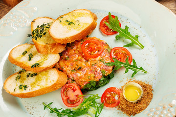 Beef tartare with egg yolk and tomato on table