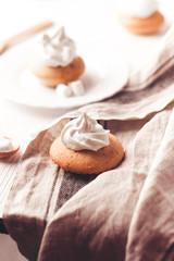 Cupcakes with vanilla cream on white wooden backdrop, vertical composition