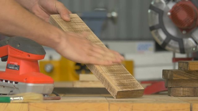 Sanding and brushing a piece of wood