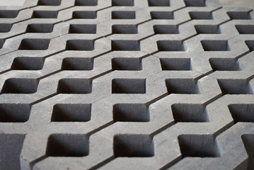 Lawn tile in cement factory. sidewalk square tiles. The Cement brick between green grass. 