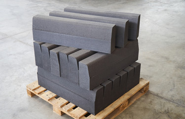 Concrete road curbs at the factory for the production of cement products, paving slabs