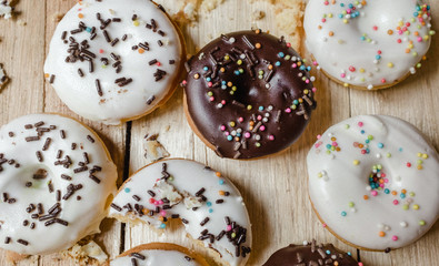 Picture of a small donuts on a wooden background. focus on donuts