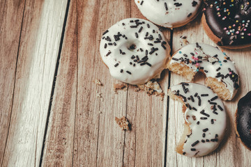 Picture of a small donuts on a wooden background. focus on donuts