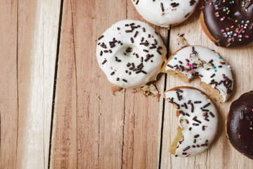 Picture of a small donuts on a wooden background. focus on donuts