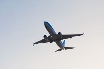 Fototapeta na wymiar flying airplane in blue sky