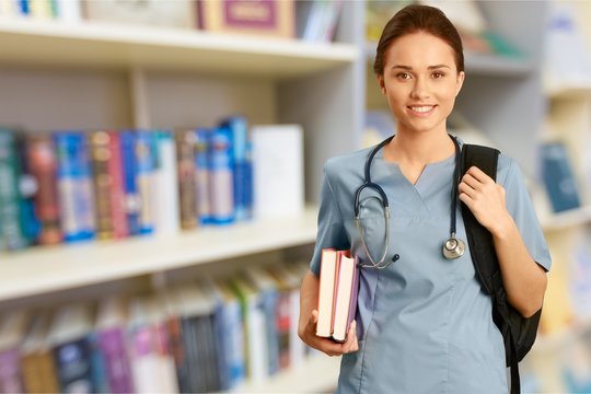 Young female doctor in library