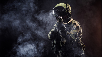 russian special forces soldier with rifle on dark background. army, military and people concept