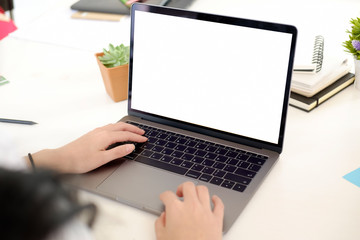 Female hands typing laptop in office