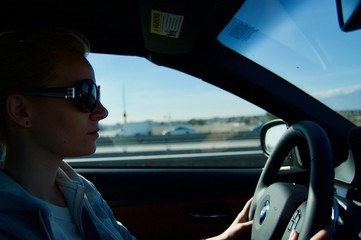 Blonde Woman driving a car