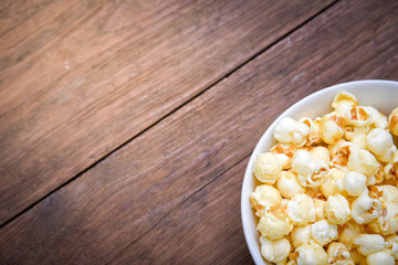 A bowl of popcorn on a wooden table
