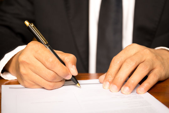 Business man signing agreement document