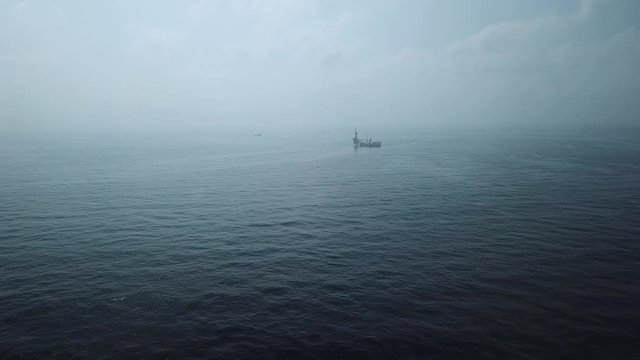 Aerial view from a drone of a tender assisted drilling rig in the middle of the ocean view 
