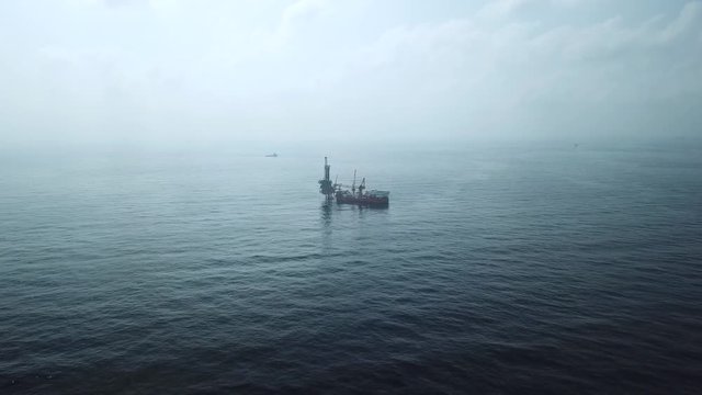 Aerial view from a drone of a tender assisted drilling rig in the middle of the ocean view 
