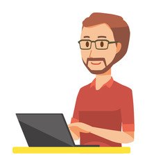 A bearded man wearing eyeglasses is operating a laptop computer