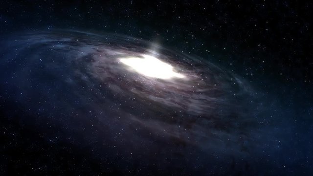 A slow approach to a large spiral galaxy in deep space.  	