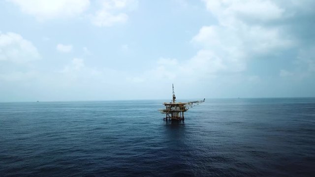 Aerial view from a drone of a small offshore platform in the middle of the ocean 
