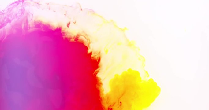 Rainbow of colors as colorful inks mix together in slow motion
