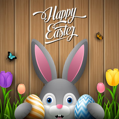 Happy easter with rabbit holding two egg colorful on wooden brown background