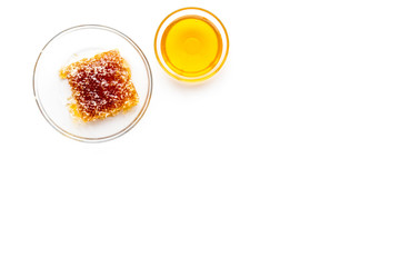 Fototapeta na wymiar Honeycomb filled with honey on plate on white background top view space for text