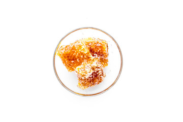 Honeycomb filled with honey on plate on white background top view space for text