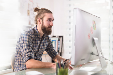 portrait of a young hipster working on a computer