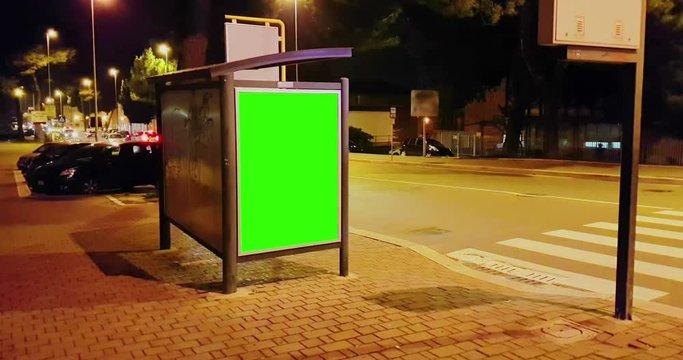billboard with a chroma key green screen on a traffic cars city night street, light night, advertisement concept