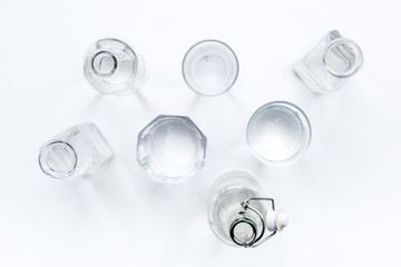 Drinks on the table. Pure water in jar and glasses on white background top view