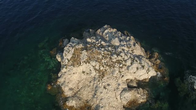 Flying above a small barron islet of the Aegean Sea in Greece