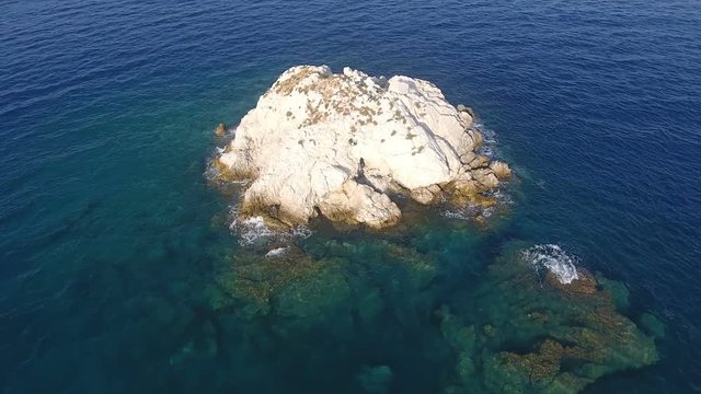 Flying above a small barron islet of the Aegean Sea in Greece