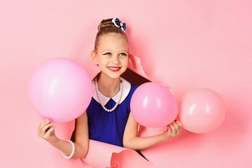 Little girl with hairstyle hold balloons. Small girl child with party balloons, celebration. Birthday, happiness, childhood, look. Kid with balloons at birthday. Beauty and fashion, punchy pastels.