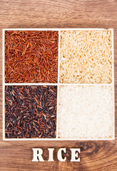White, brown, black and red rice with inscription on board, healthy gluten free food concept