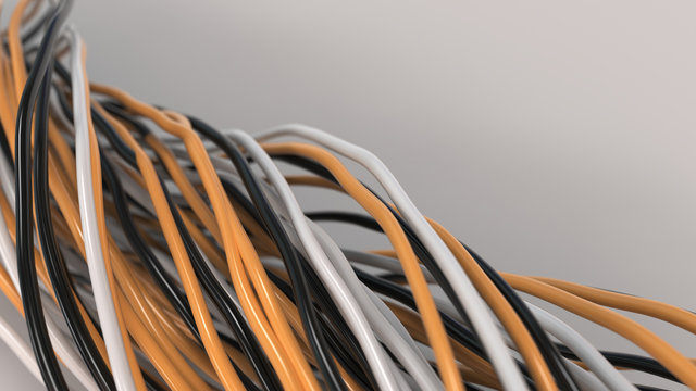 Twisted black, white and orange cables and wires on white surface